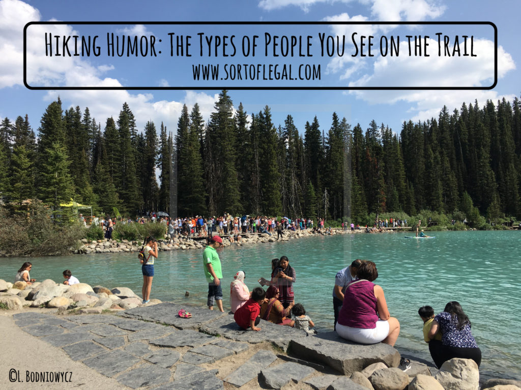 Look towards the back. Crowds lined up to take a photo in a single spot at Lake Louise in the afternoon.